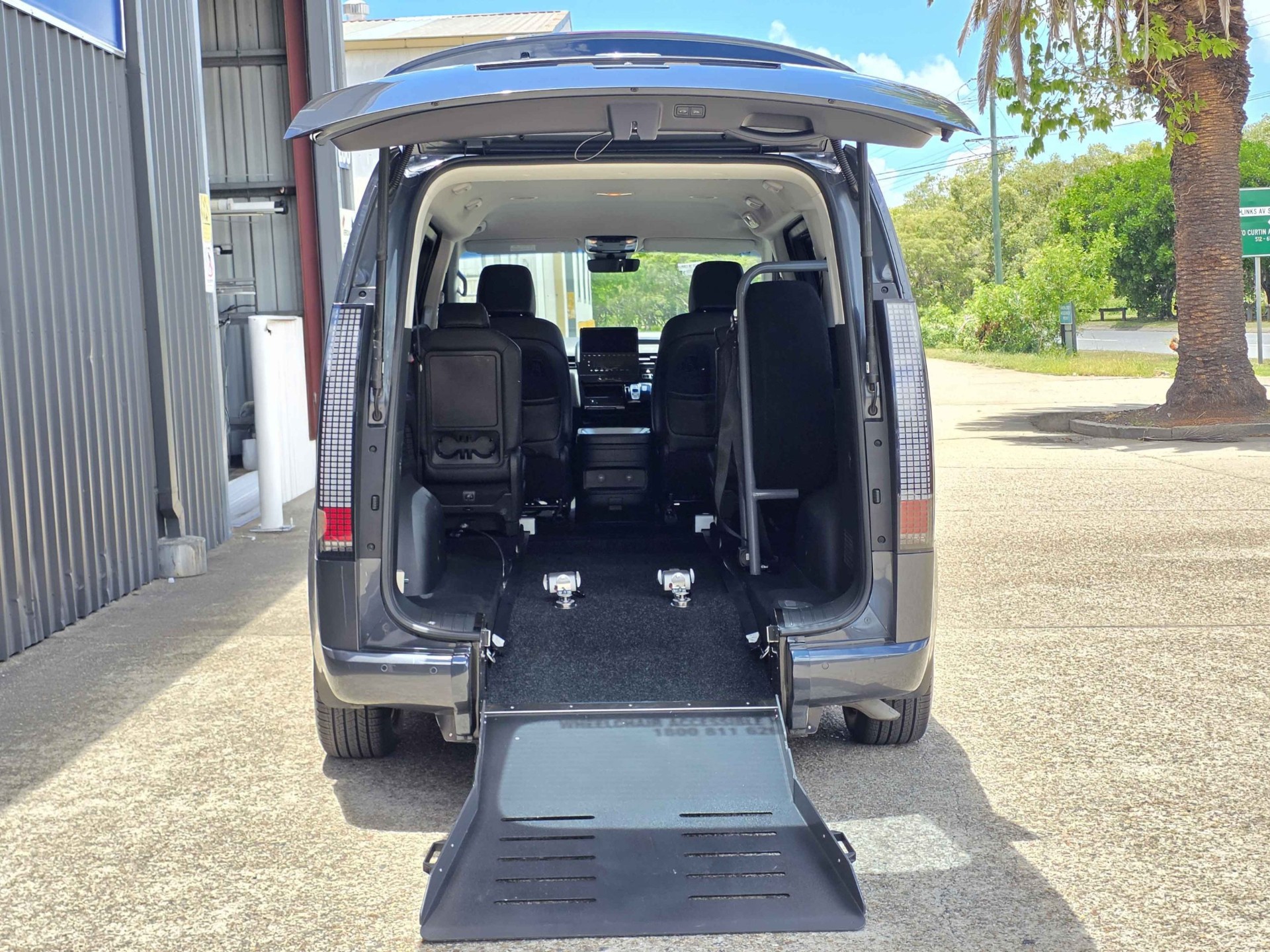 Rear ramp loading a wheelchair into the van