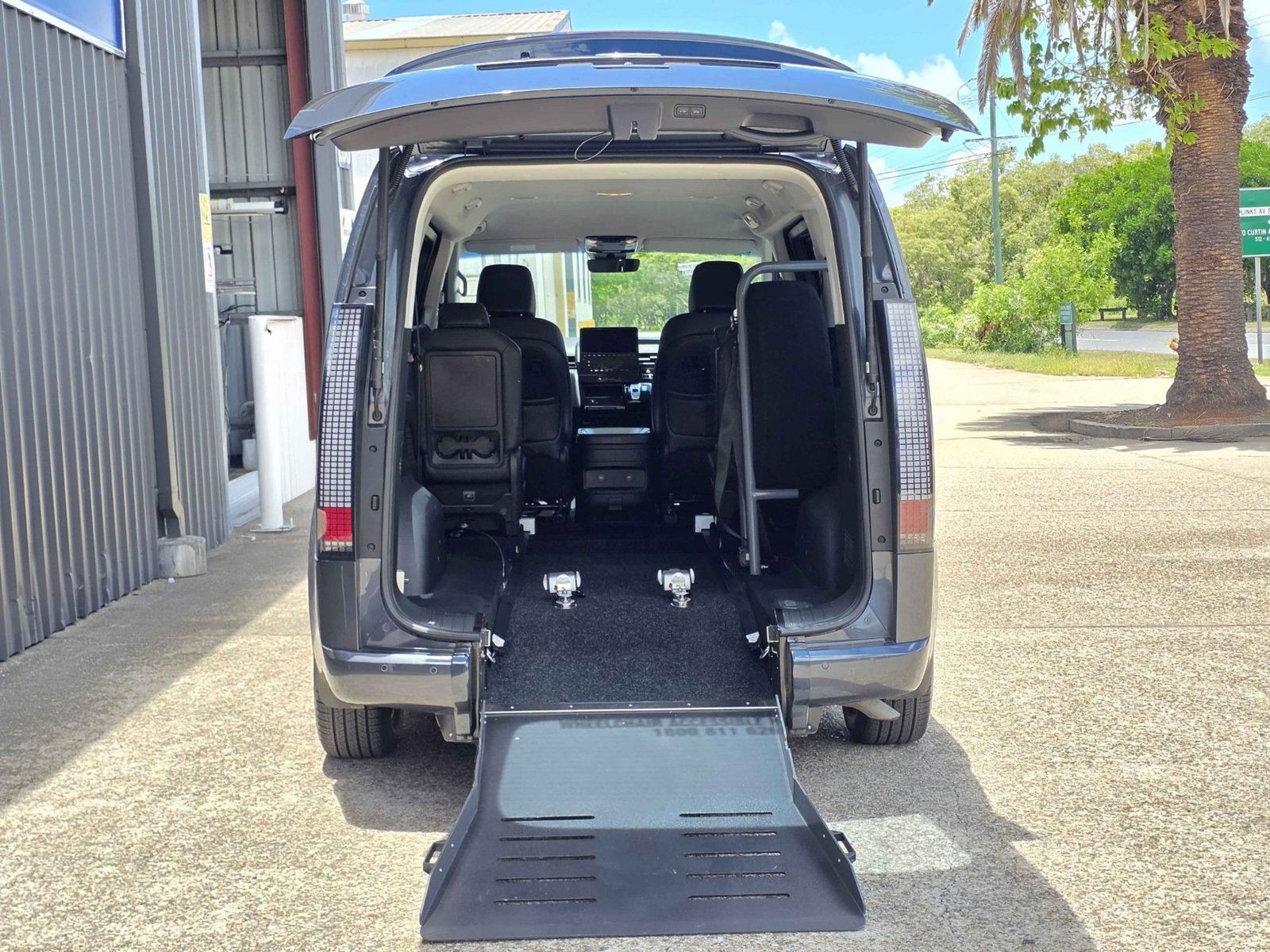Rear ramp loading a wheelchair into the van